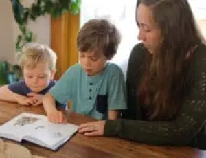 A mother teaching her son to read